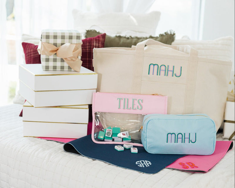 Mahjong embroidered monogram tile mat styled with matching pouches and tote bags.