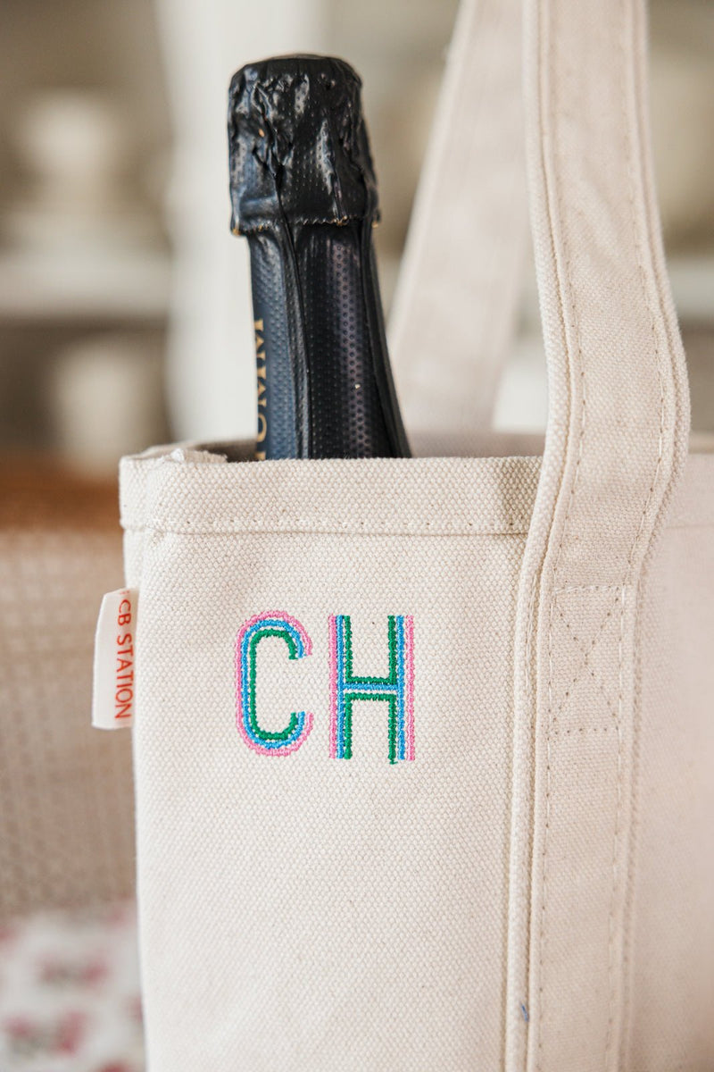 Monogrammed wine tote in neutral canvas with blue initials