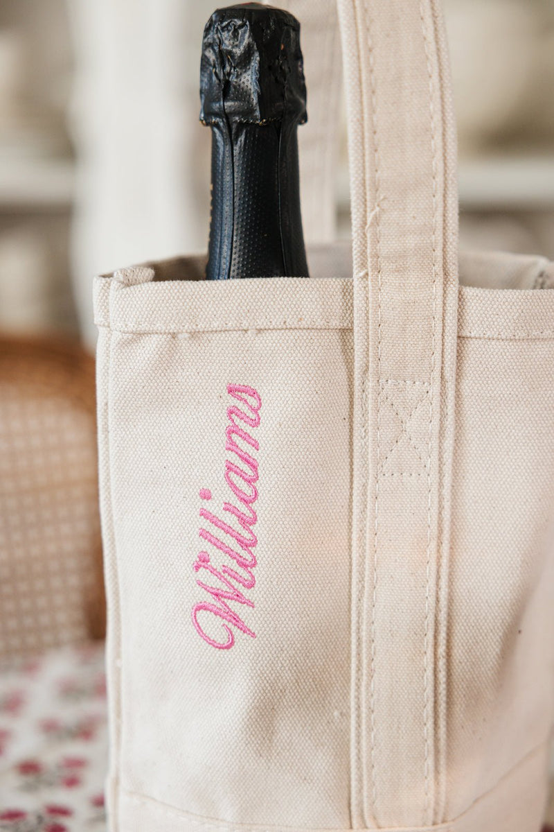 Canvas wine tote with custom embroidered name, elegant and eco-friendly wine gifting bag.