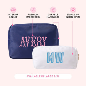 Navy nylon zippered pouch embroidered 'Avery' in pink and a white nylon pouch embroidered 'MW' in blue, with icons describing interior lining, premium embroidery, durable hardware, and that it stands up when open.