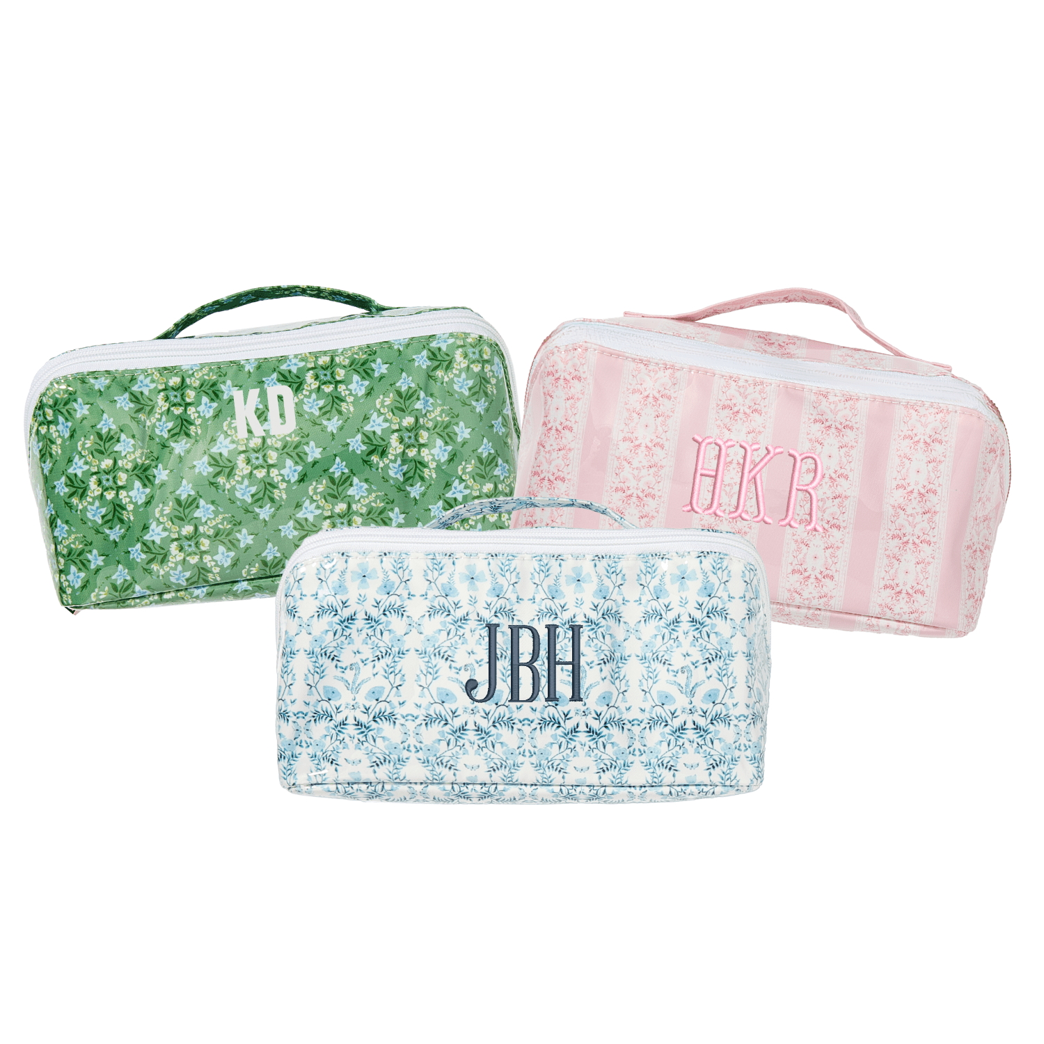 Set of three flat lay pouches in green, pink, and blue floral prints with monogram initials.