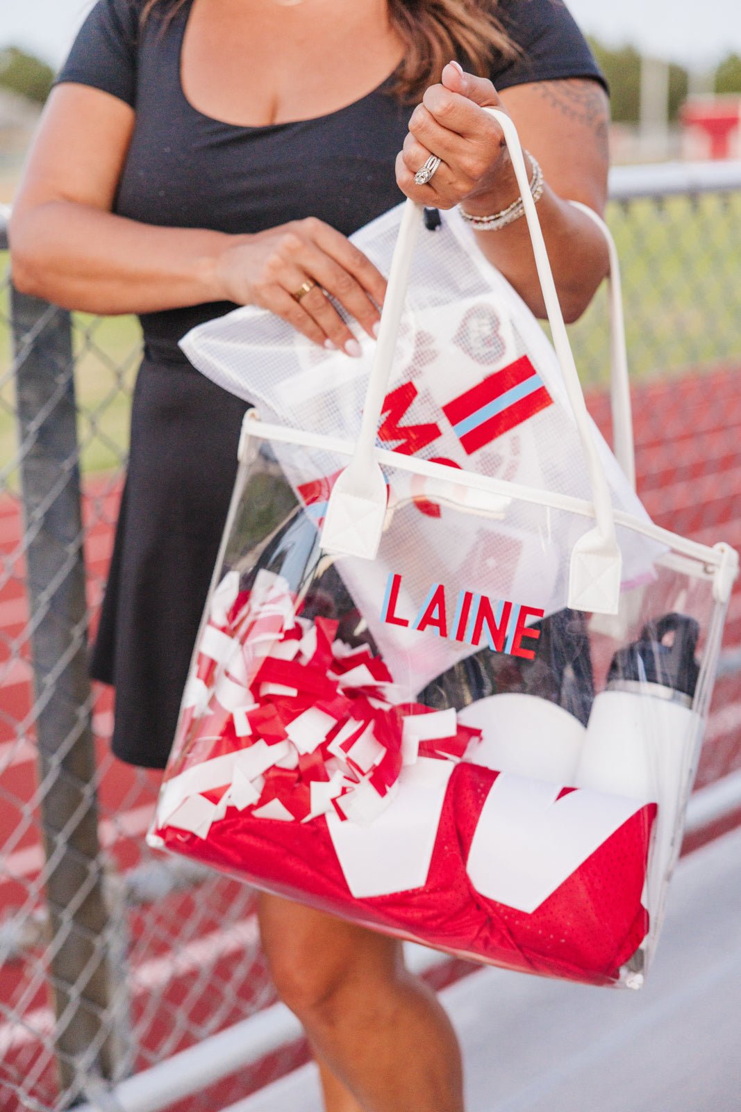 Two clear vinyl tote bags with cream handles, embroidered with red “WILSON” and green “#22.”