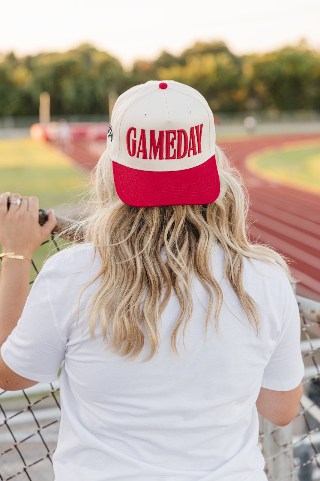Cream-front vintage trucker hat with black brim, featuring raised black puff embroidery spelling “GAMEDAY.”