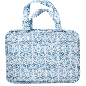 Blue floral hanging toiletry bag with top handles, clear coated finish, and customizable embroidered monogram.