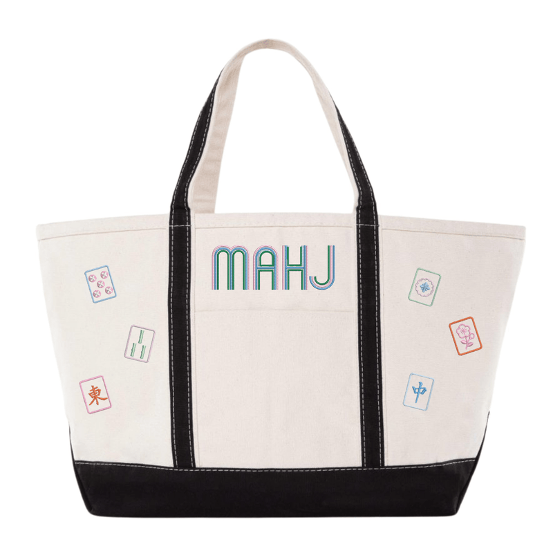 White canvas boat tote with black trim, embroidered "MAHJ" and colorful mahjong tile icon patches