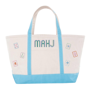 White canvas boat tote with light blue trim, embroidered "MAHJ" and colorful mahjong tile icon patches