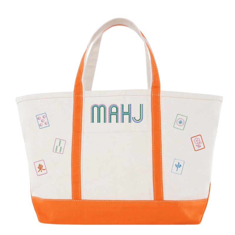 White canvas boat tote with orange trim, embroidered "MAHJ" and colorful mahjong tile icon patches