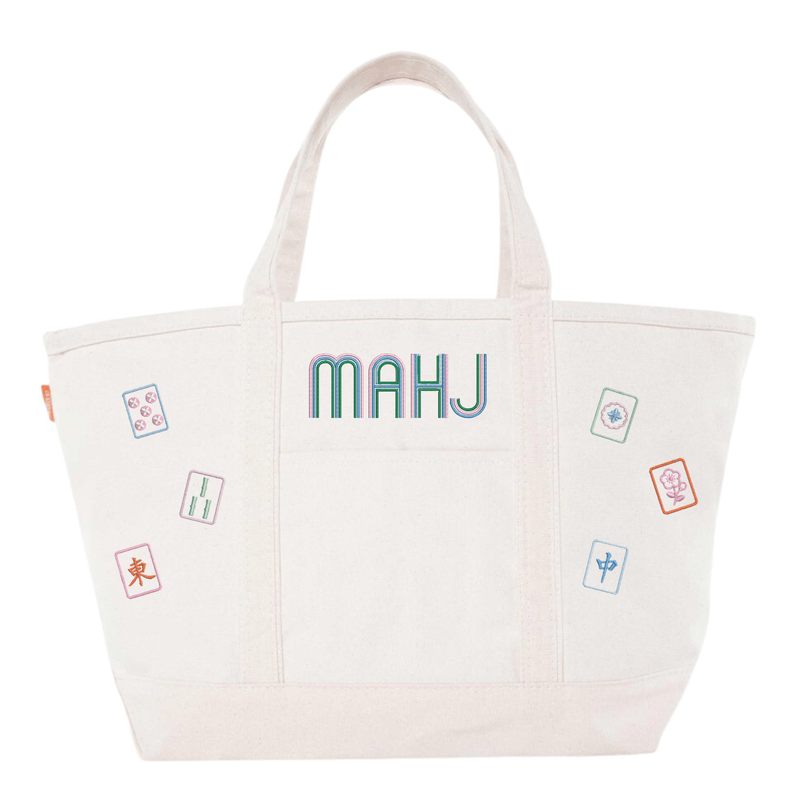 White canvas boat tote with ivory trim, embroidered "MAHJ" and colorful mahjong tile icon patches