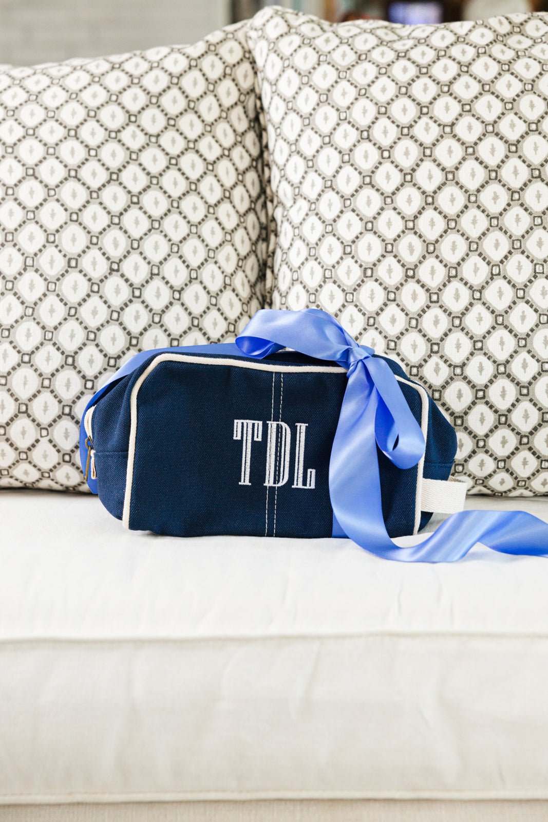 A navy Personalized Canvas Travel Dopp Kit from Sprinkled with Pink, featuring a monogrammed "NDW" in elegant embroidery. Designed for both style and functionality, this durable canvas toiletry bag is accented with white piping and a sturdy zipper closure, making it the perfect addition to a custom travel essentials set. Ideal for gifting or personal use, this monogrammed dopp kit is great for organizing grooming products, cosmetics, and travel necessities in a stylish and practical way.