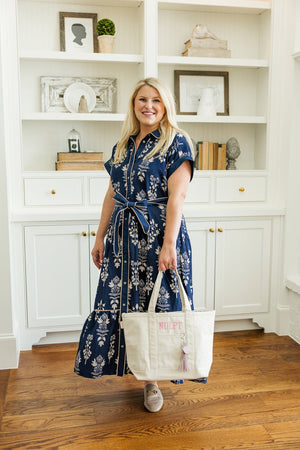 Woman carrying a white Needlepoint Canvas Project Tote, ideal for transporting craft supplies.