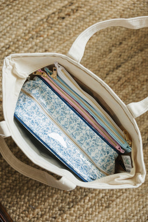 Interior of Needlepoint Canvas Project Tote showing neatly organized craft and stitching supplies.