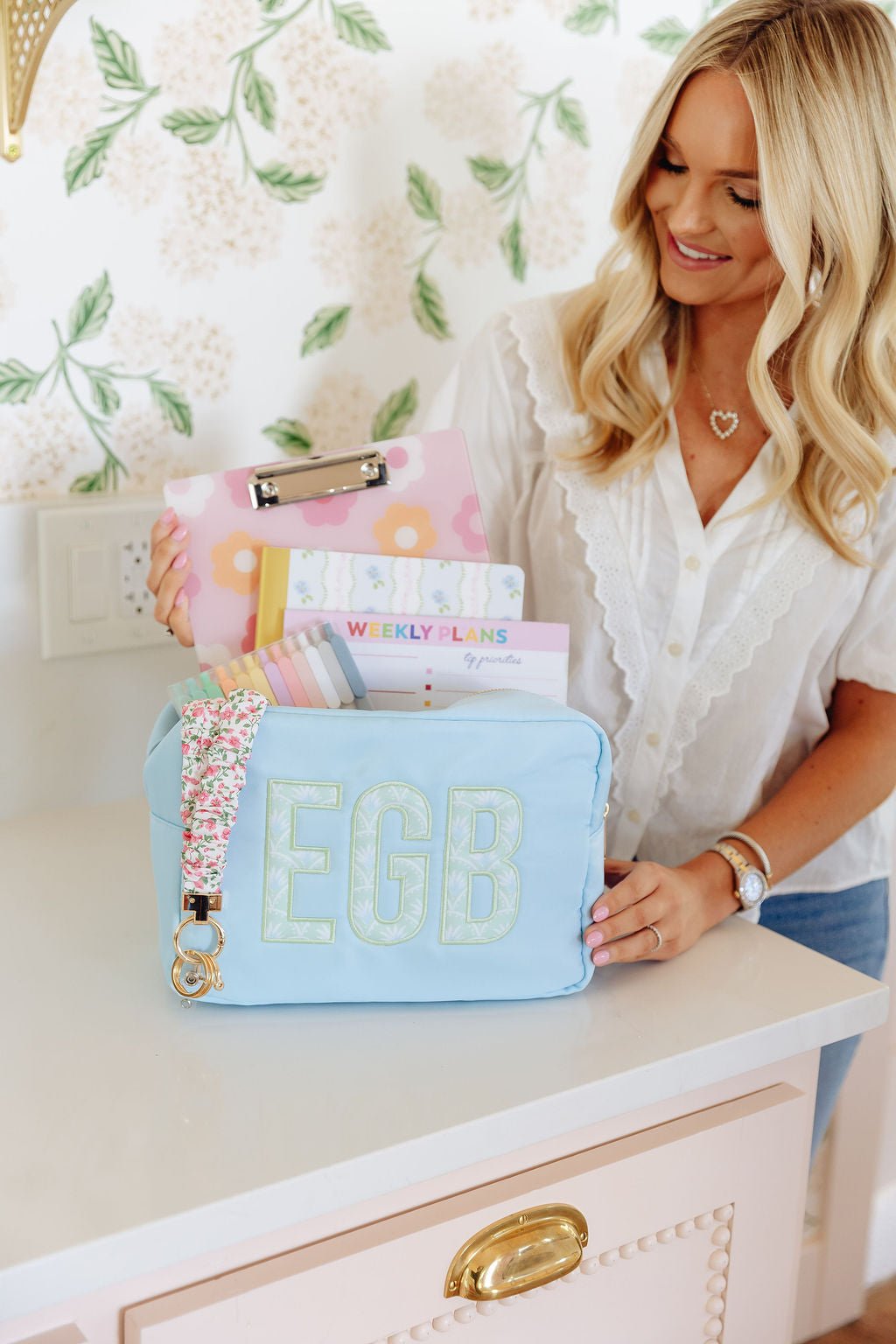 Blue nylon pouch set in large and extra-large sizes with embroidered monogram.