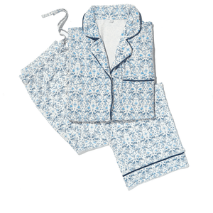 Blue floral pajama set with button-down top and matching pants, accented with navy trim details.