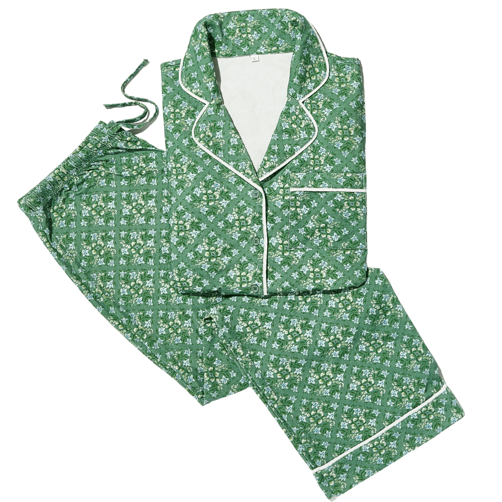 Green floral pajama set with button-down top and matching pants, finished with white trim piping.