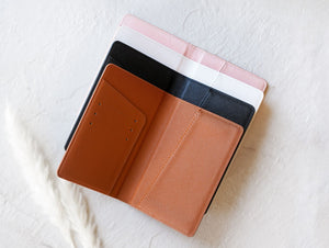 Passport holders are laid open to show the card slots on the inside.