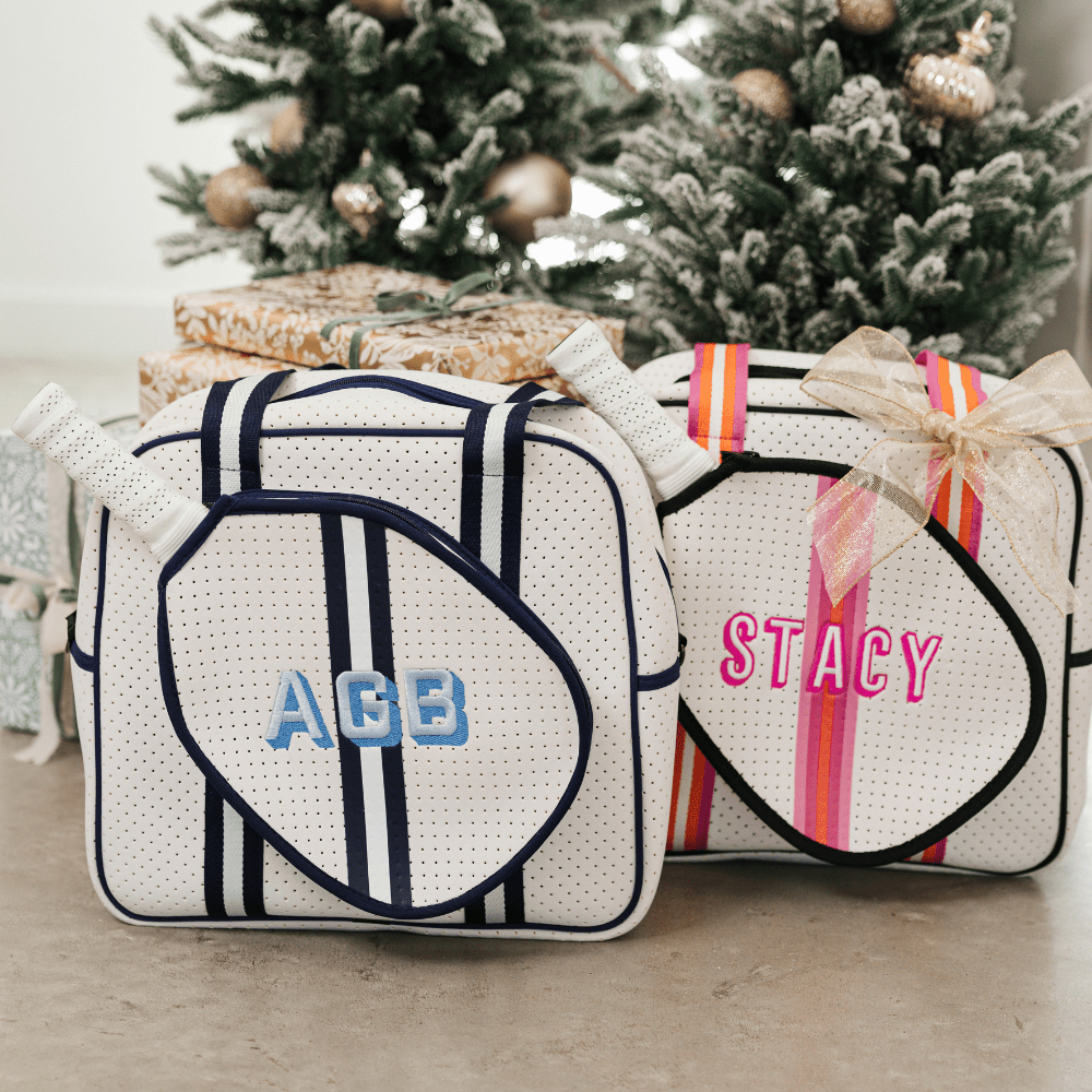 A navy and white pickleball bag is customized with a blue monogram.