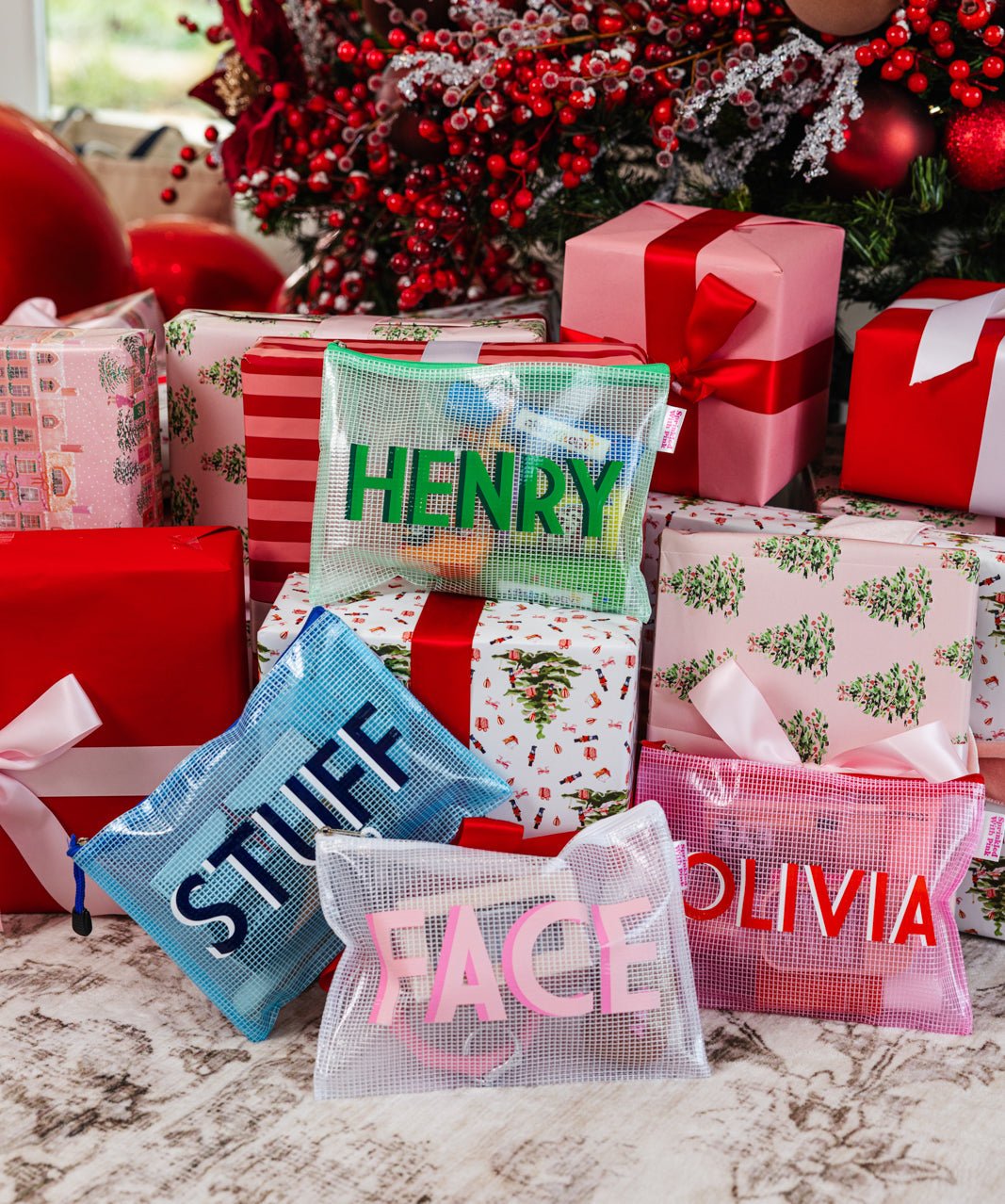 A group of pink, blue and white pool bags are customized with colorful monograms.