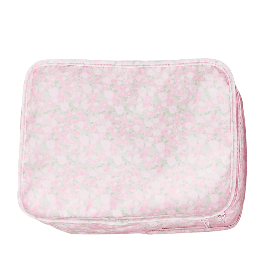 Pink floral packing cube, top-down view on a white background