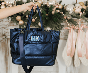 Navy blue puffer tote bag with embroidered monogram, lightweight personalized travel bag.