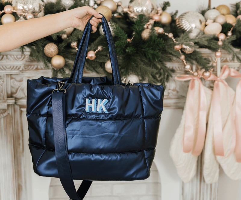 Navy blue puffer tote bag with embroidered monogram, lightweight personalized travel bag.