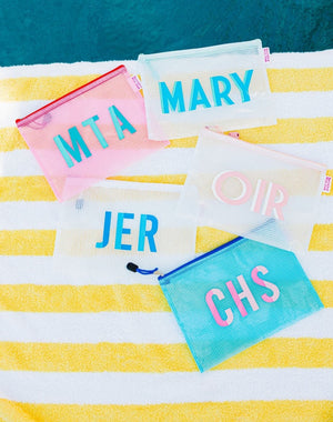 A group of pool bags are customized with colorful monograms