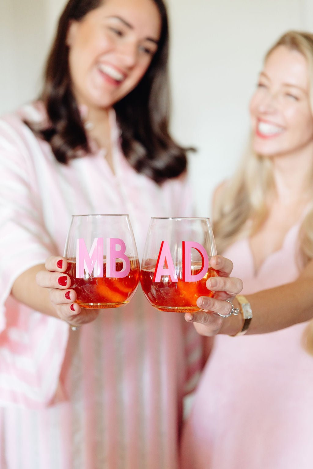 Three wine glasses with different colored shadow monograms