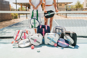 A group of pickleball bags and paddle covers are customized with colorful embroidered monograms and names