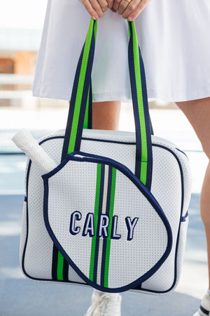 A green and navy pickleball bag is customized with a navy and white embroidered name
