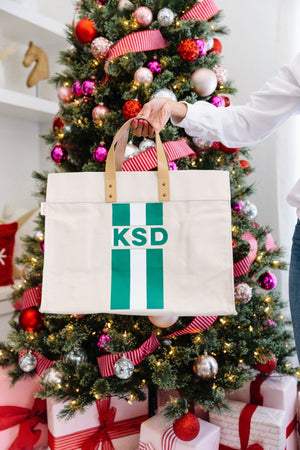 Striped monogram weekender bag by Sprinkled With Pink displayed with holiday décor, personalized travel bag gift