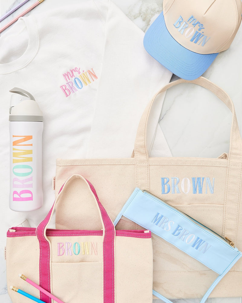 Teacher Essentials Bundle – @PBANDJ4THGRADE x SWP: natural canvas tote, clear nylon pouch, insulated water bottle, embroidered sweatshirt, and trucker hat