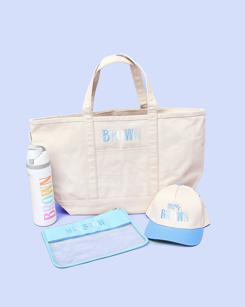 Teacher Essentials Bundle – @PBANDJ4THGRADE x SWP: canvas tote with navy trim, rainbow “BROWN” bottle, blue-brim hat, clear pouch