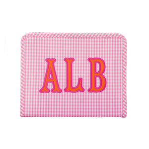 Pink gingham TRVL Roadie pouch with rounded corners appliqued 'ALB' in pink and orange, on a white background.