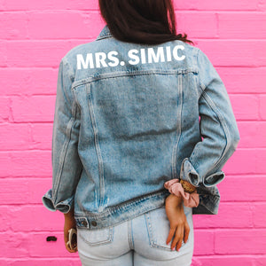 A customized jean jacket which reads "Mrs. Simic" across the shoulders.