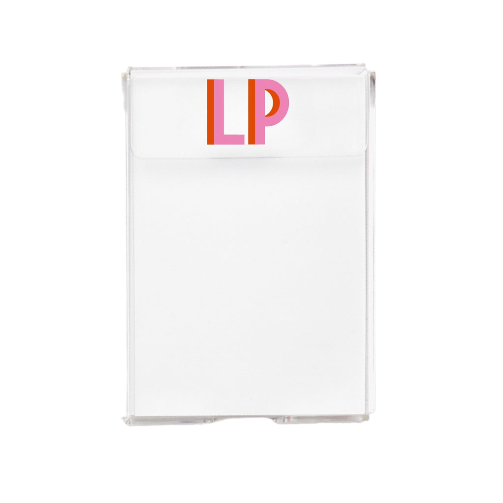 A clear acrylic notepad customized with initials