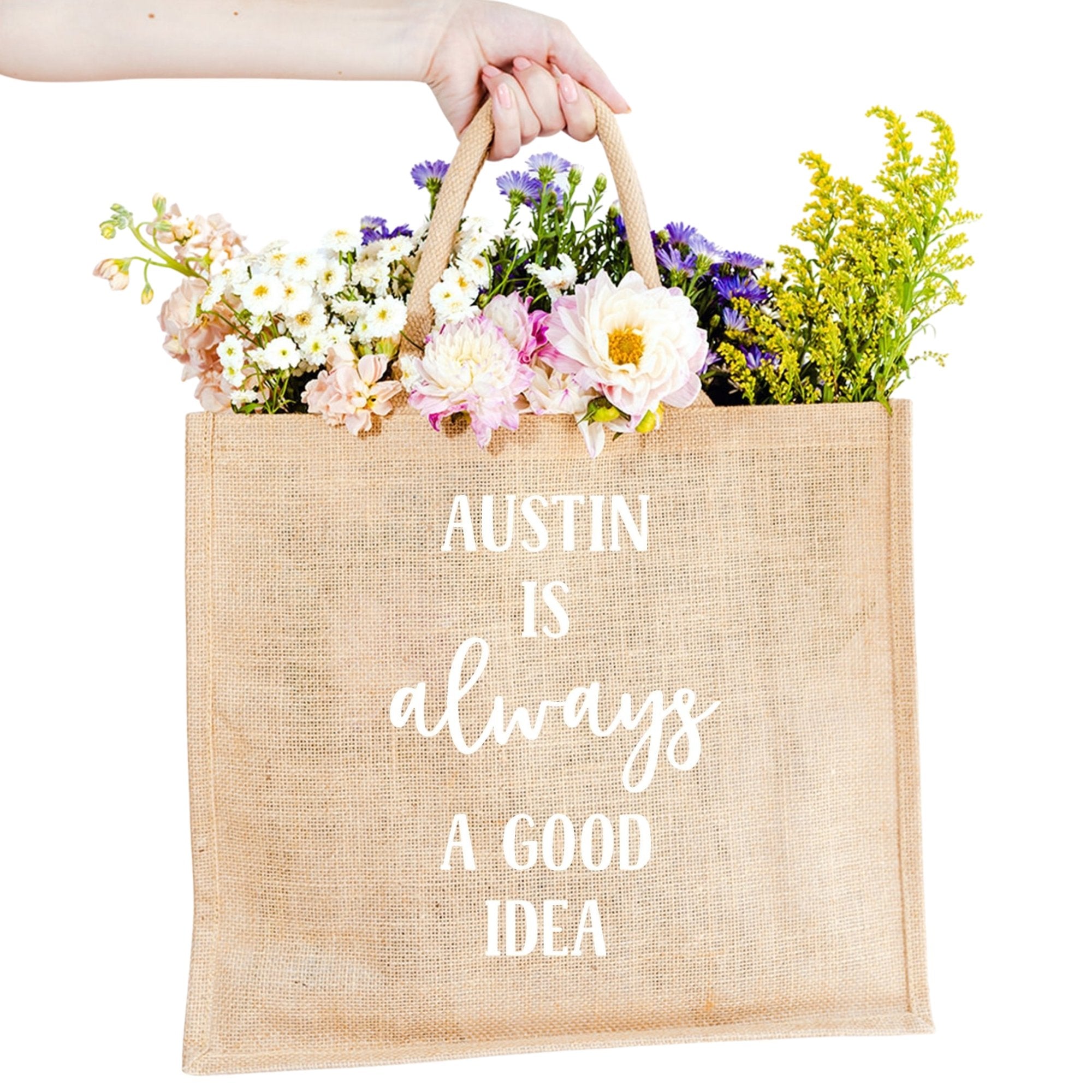 A custom jute bag reads "Austin Is Always A Good Idea" on the front