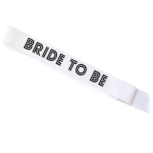 A white sash that reads "Bride To Be"