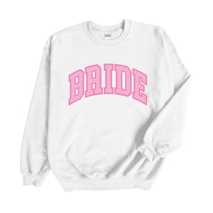 A white sweatshirt with "Bride" written on the front in pink