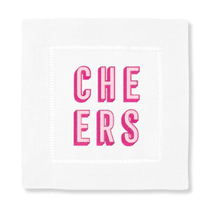 A cocktail napkin with the word "Cheers" embroidered in pink thread.