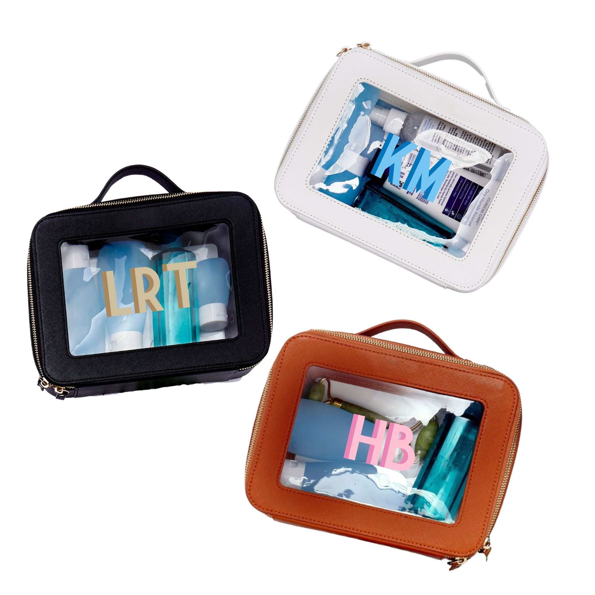 A group of white, tan, and black train cases are personalized with colorful monograms.