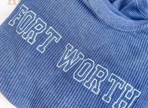 A corded embroidered sweatshirt with "Fort Worth" embroidered on the front