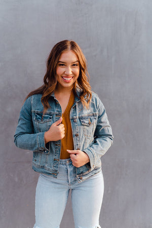 A woman wears a customized jean jacket.