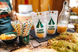 Two party pouches are customized with a green "Camp Premo" design