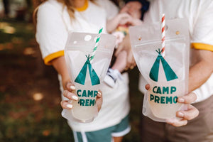 Two party pouches are customized with a green "Camp Premo" design