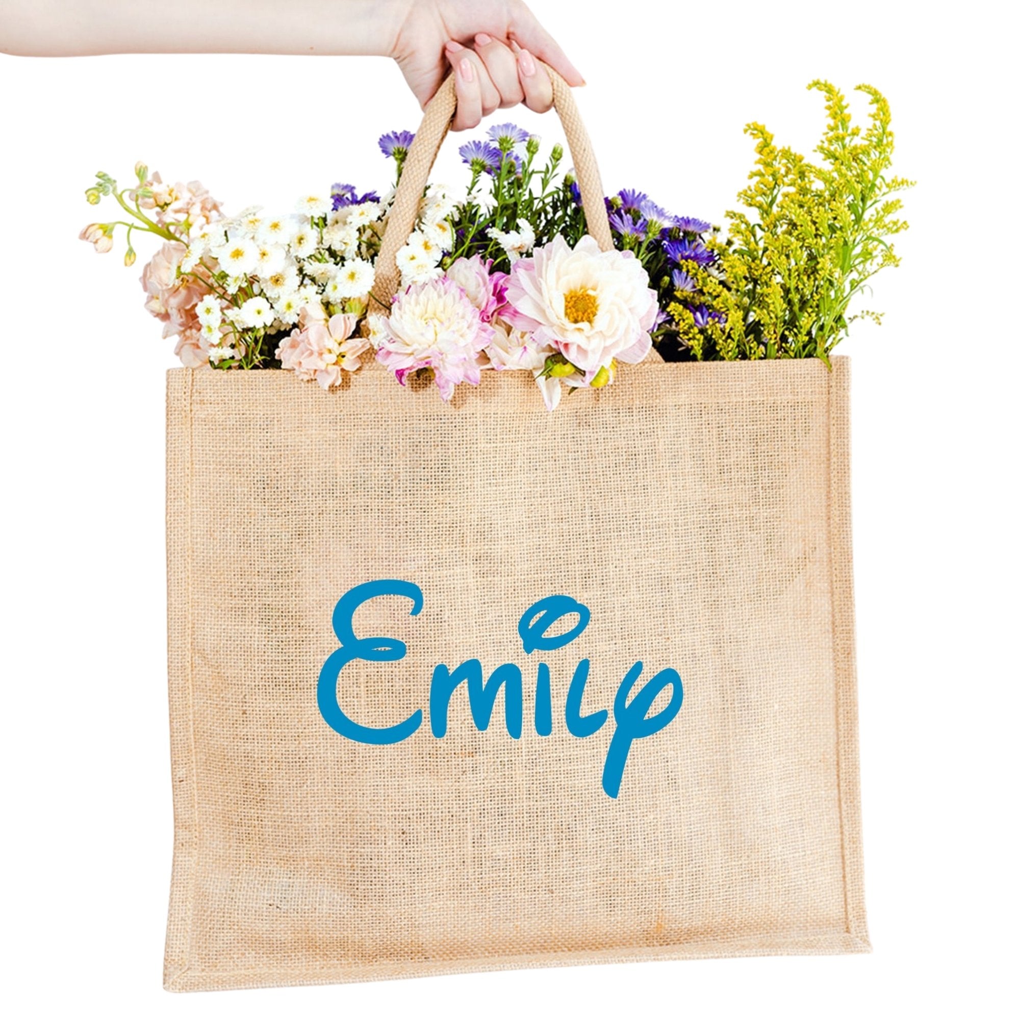 A custom jute bag reads "Emily" on the front in Magic Adventure Park font