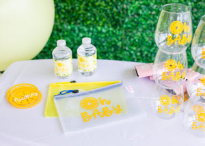 An assortment of items are personalized with a yellow "Oh Baby" design