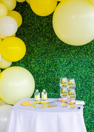 A table is set up with a bunch of yellow personalized party favors
