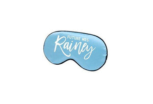 A light blue sleep mask is customized to read "Future Mrs. Rainey" in a white font.