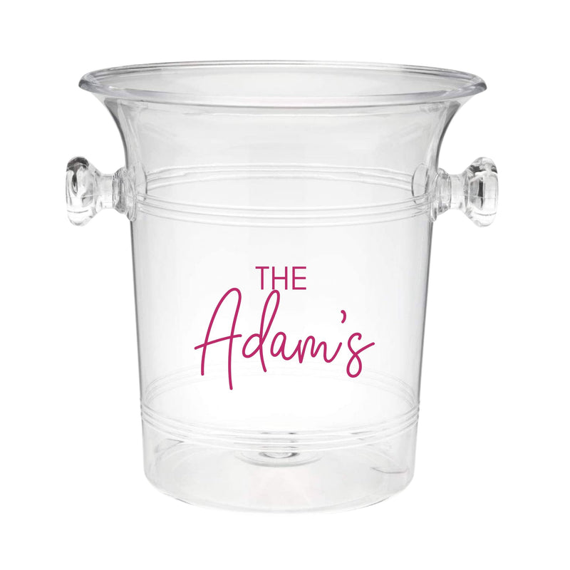 A clear ice bucket with "The Adam's" on the front