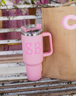 A light pink tumbler with "SB" monogrammed on the front