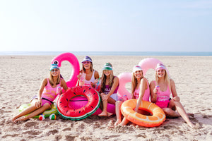 A group of girls on the beach wear an assortment of customized goodies